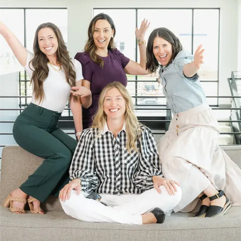 Shannon Fitzgerald and three women smiling together on a sofa